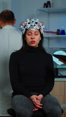 woman undergoing neuroscience experiment with eeg cap in a laboratory