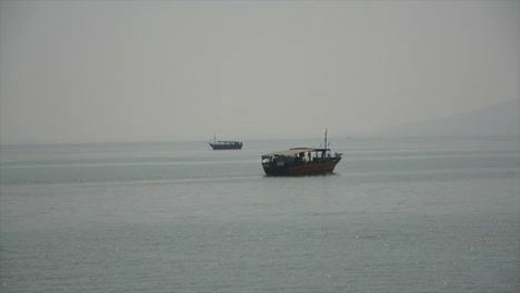 two old fashioned boats sailing past each other on the sea of galilee in israel