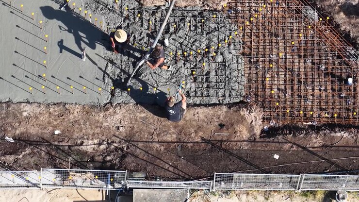 Construction Workers Pouring Concrete for New Foundation