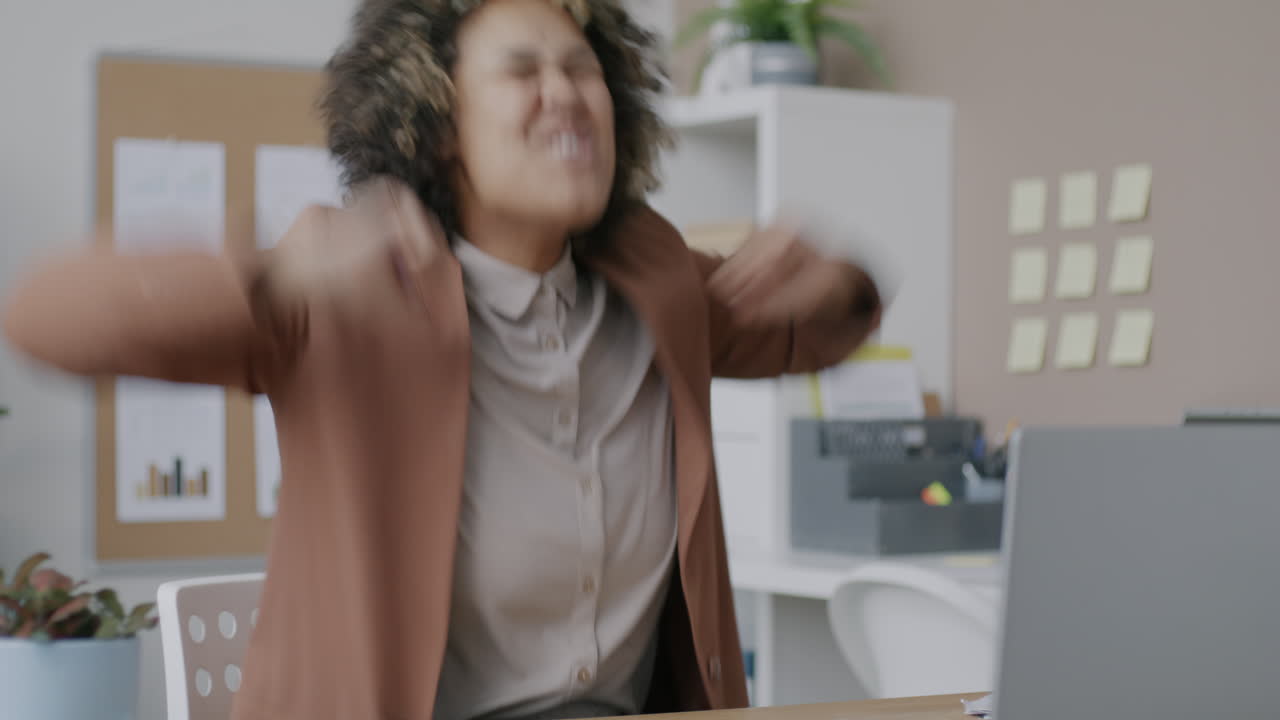 Happy businesswoman stretching in office