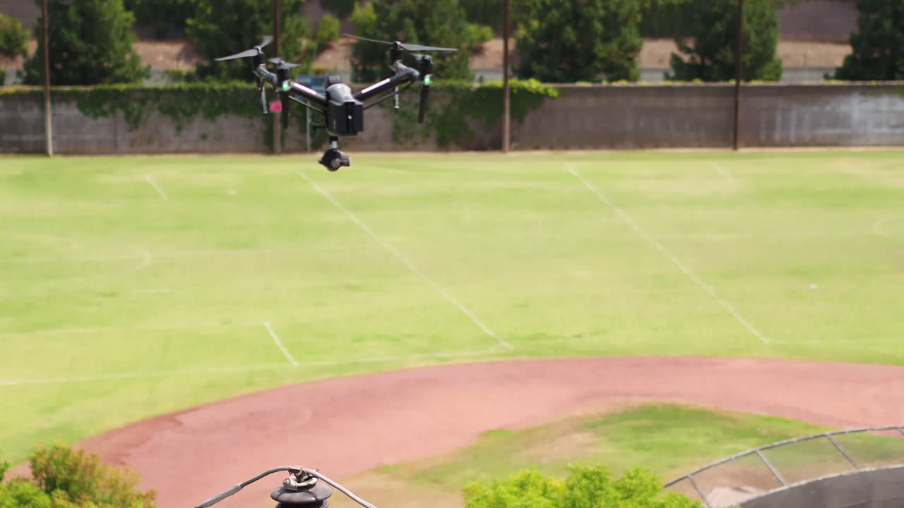 Drone inspecting distribution power pole from the air