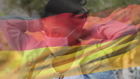 german flag waving against woman wearing face mask