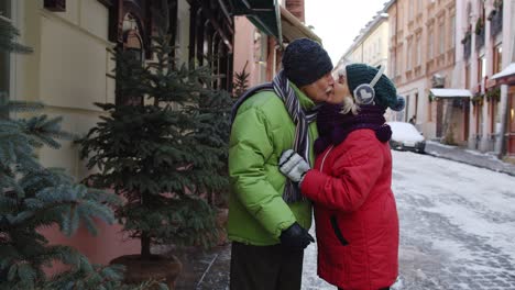 Elderly-couple-grandmother-grandfather-tourists-traveling,-walking,-hugging,-embracing,-making-kiss