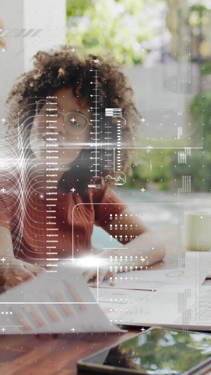 Vertical video: Woman marking charts using pencil, activating HUD ANALYSIS COMPLETE, tablet visible