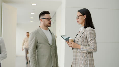 business people talking in an office corridor