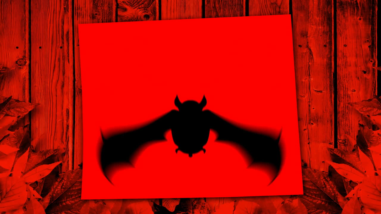 silueta de murciélago sobre fondo rojo con textura de madera y hojas de otoño