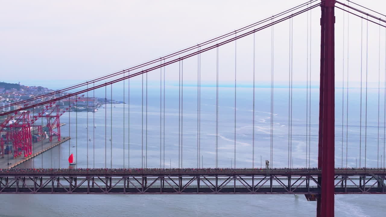 Side-on aerial drone shot of half marathon and 10K long-distance running event in Lisbon, Portugal, Europe. Commercial grading, Alcantara docks