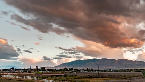 puesta de sol colorida y dinámica sobre una montaña mientras se juntan las nubes de tormenta - lapso de tiempo