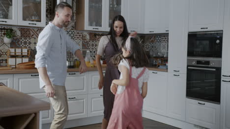 happy family dancing in the kitchen