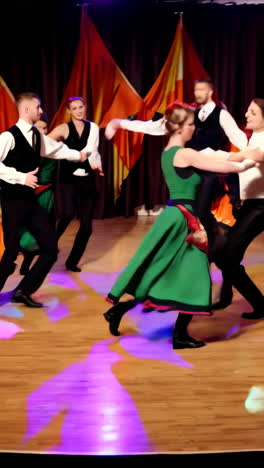 energetic folk dance performance on stage with colorful backdrops