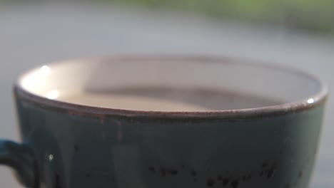 close-up of a steaming cup of coffee