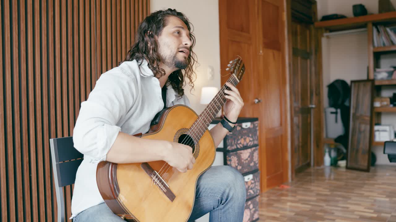Man playing guitar in a room
