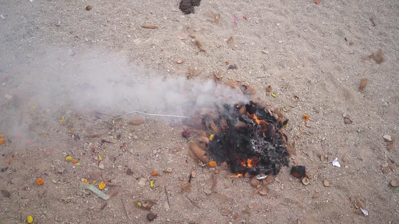 Fire and smoke coming out of burning coconut shells waste