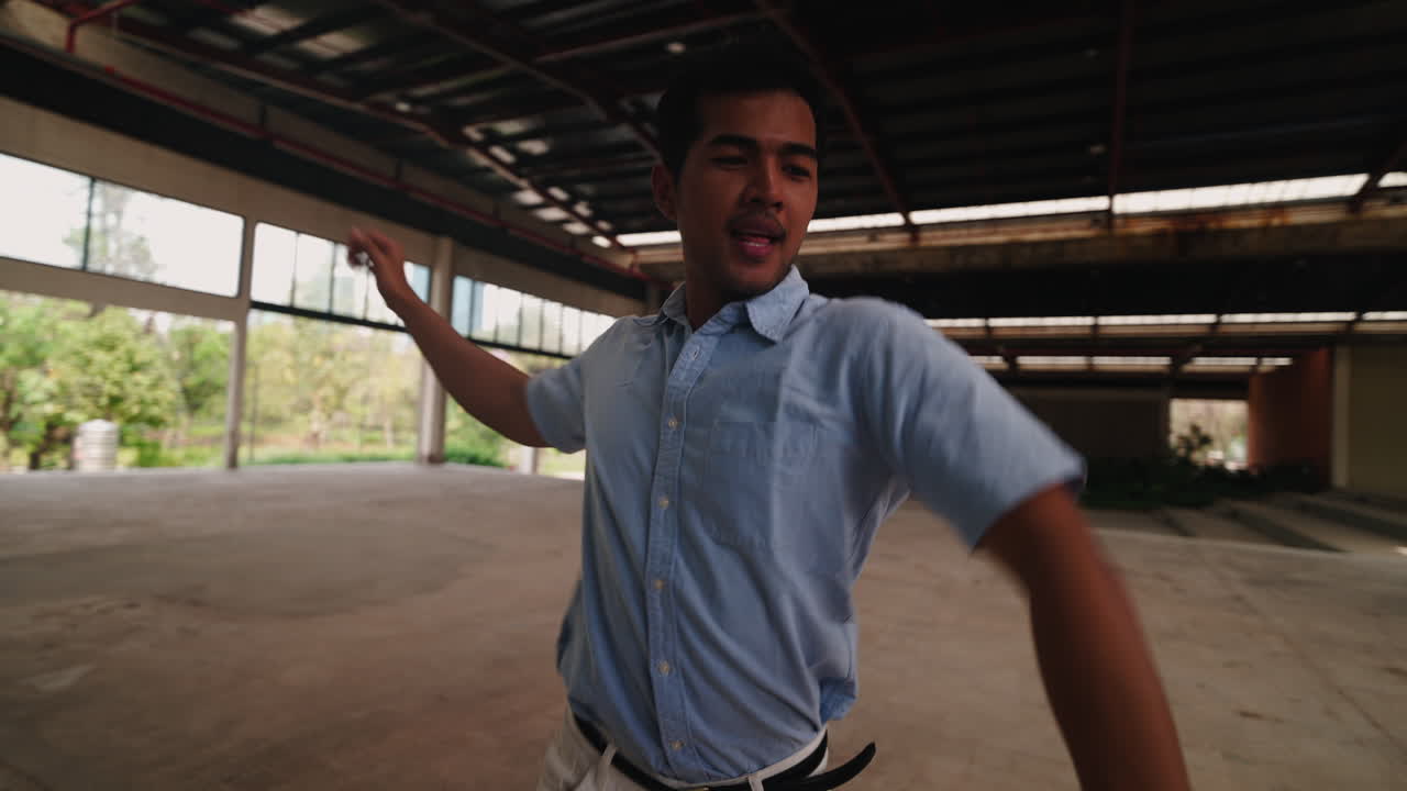Man dancing in an empty warehouse
