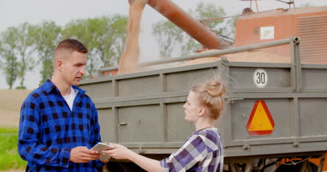 female farmer discussing with businessman on farm 7