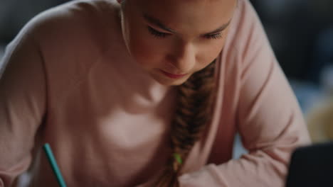 diligent girl doing math homework indoors