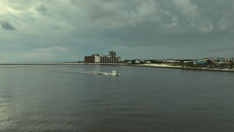 Aerial-view-of-fishing-boat-returning-at-Perdido-Pass-in-Orange-Beach,-Alabama