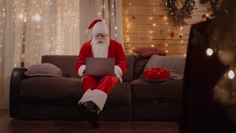 general plan santa answers emails browses the internet bank and works at a laptop