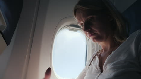 a young woman is reading a magazine in the cockpit of an airplane comfort and entertainment in the j