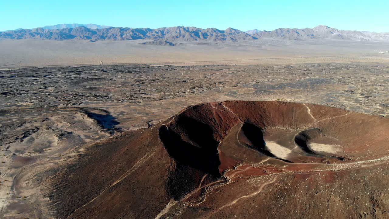 Aerial footage flying over the Amboy Crater. Long extinct, the Amboy Crater is an cinder cone volcano that rises above a huge lava field in the eastern Mojave Desert of southern California.