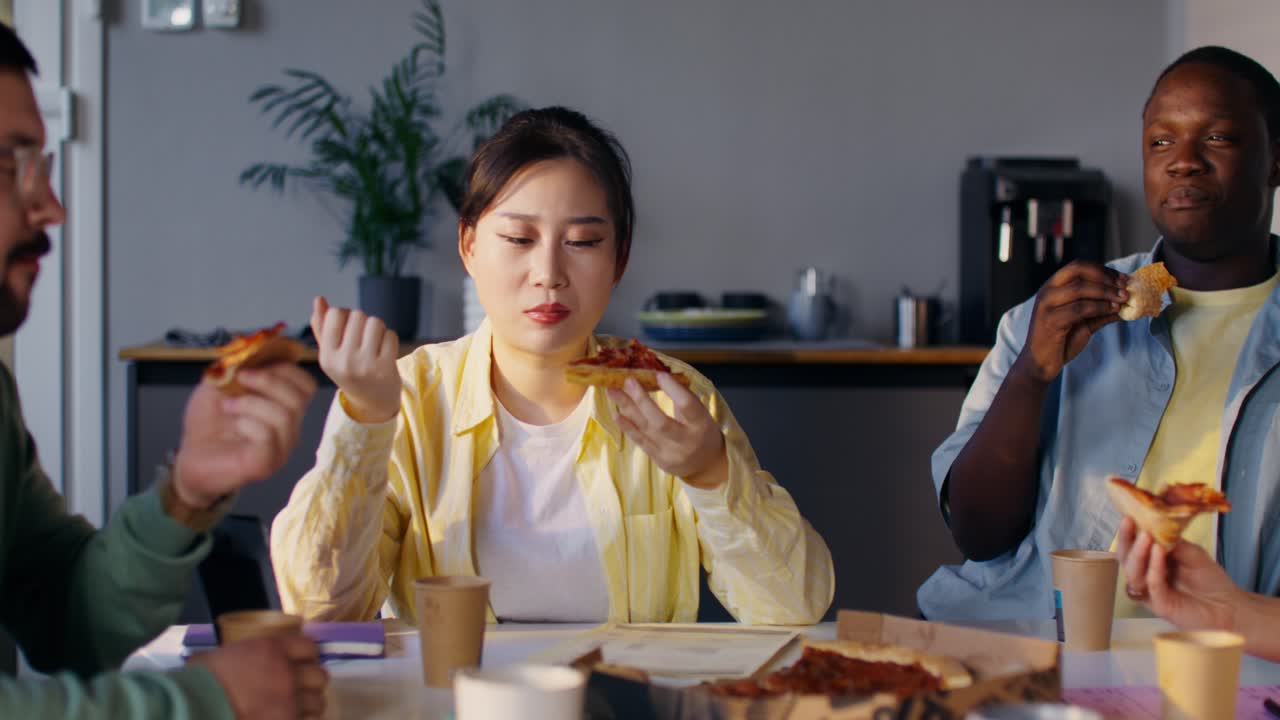 Coworkers Eating Pizza During a Meeting
