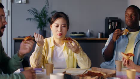 Coworkers Eating Pizza During a Meeting