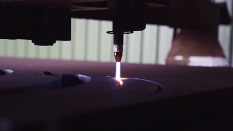 closeup with the plasma torch of a cnc cutting machine