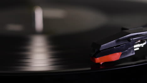 a close up shot of a record-vinyl spinning on a turn table