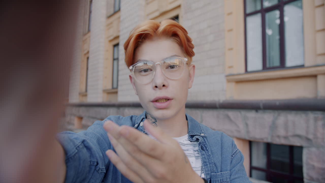 Young person taking a selfie outside a building