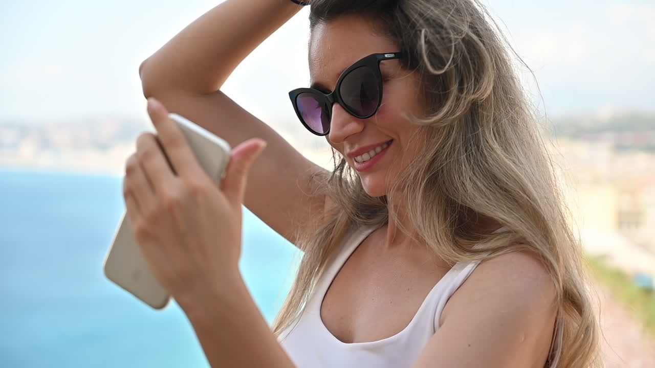 Woman taking a selfie on the coast
