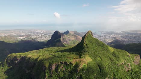 Le-pouce-mountain-overlooking-port-louis-under-clear-skies,-aerial-view