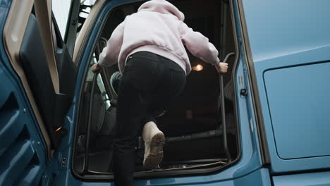 truck driver getting in truck