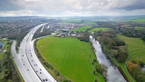 Aerial-drone-cinematic-video-footage-of-the-M1-Motorway-near-the-city-of-Wakefield,-West-Yorkshire,-UK