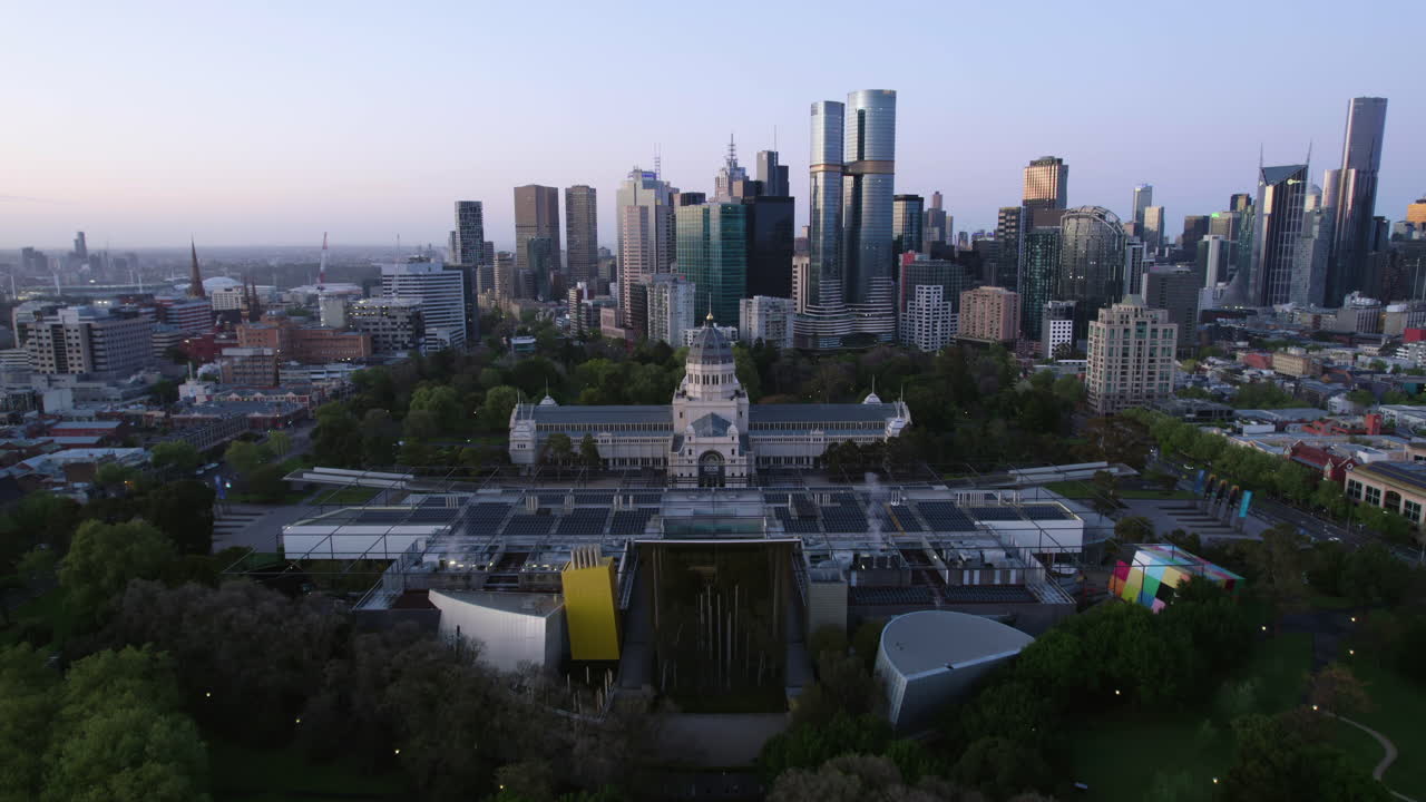 Drone flying toward the museum and the Royal Exhibition Building, dawn in Melbourne