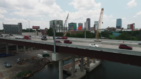 Busy-bridge-in-Arkansas-crossing-over-river,-aerial-drone-view,-Little-rock