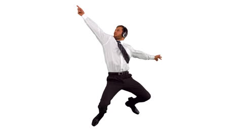 Businessman-jumping-up-and-dancing-while-listening-to-music