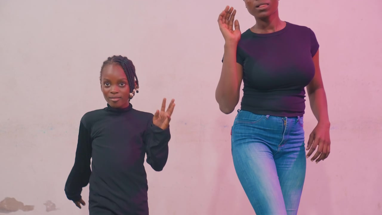 Black mother and child practicing steps, closeup frames against pastel wall, focused choreography rehearsal with measured tempo, mother guiding posture while child studies moves, intimate teaching