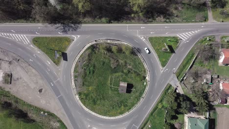 roundabout traffic of cars and trucks on the circle ring road aerial top view.