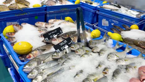 assorted fish and lemons on ice display