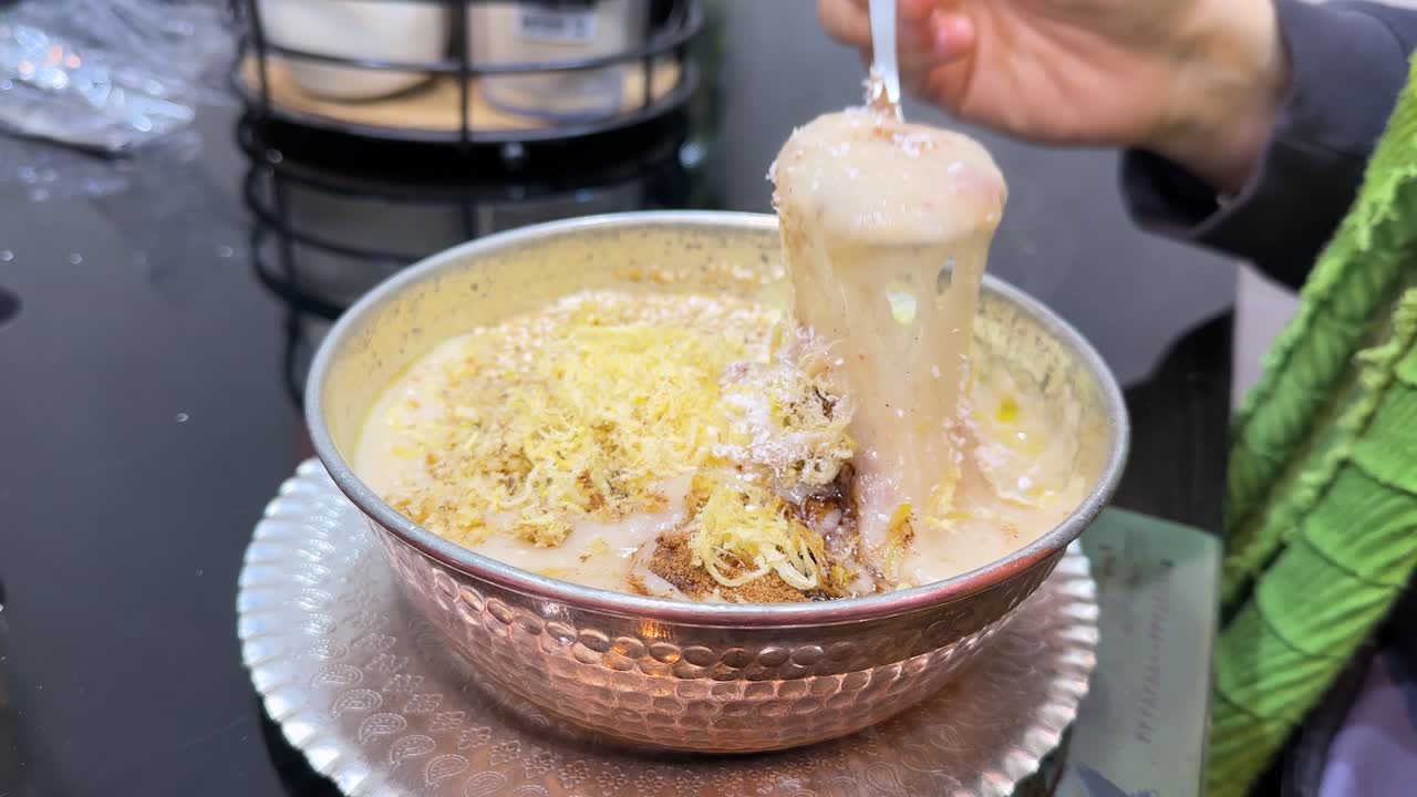 Halim the Persian street food healthy pulled beef stew with lentils mutton chicken garnished coconut sesame cinnamon spices healthy dish spicy curry masala Ramadan dinner Tehran Iran local cuisine