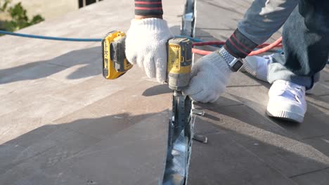 Asian-Worker-Doing-Roof-Tiles-Installation,-Cutting,-Measuring-Process,-Close-Up