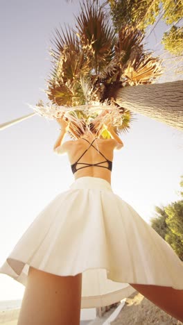 woman in white skirt near palm tree