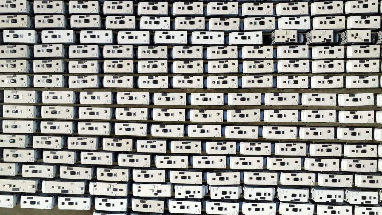Aerial View Of Imported Recreational Vehicles Parked In Parallel Rows At Storage Lot In Richmond, Canada. overhead shot