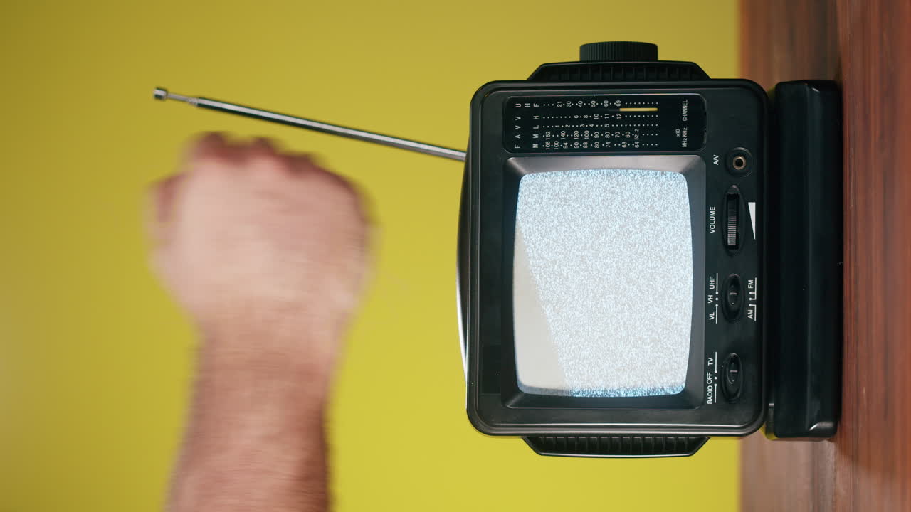A vintage portable television with static noise