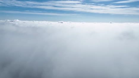 Drone-Flying-At-Above-Clouds-In-Blue-Sky-Skyline