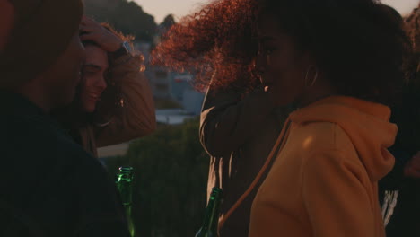 african-american-woman-dancing-group-of-diverse-friends-hanging-out-enjoying-rooftop-party-dance-music-at-sunset-drinking-having-fun-on-weekend-gathering