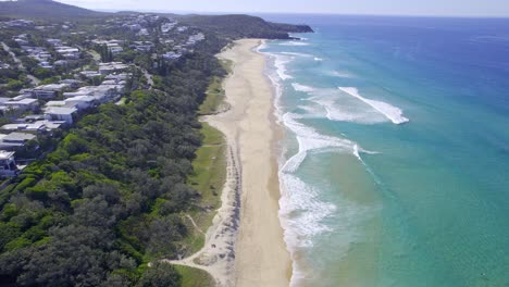 panoramic view over sunshine beach with turquoise seascape in queensland, australia - drone shot