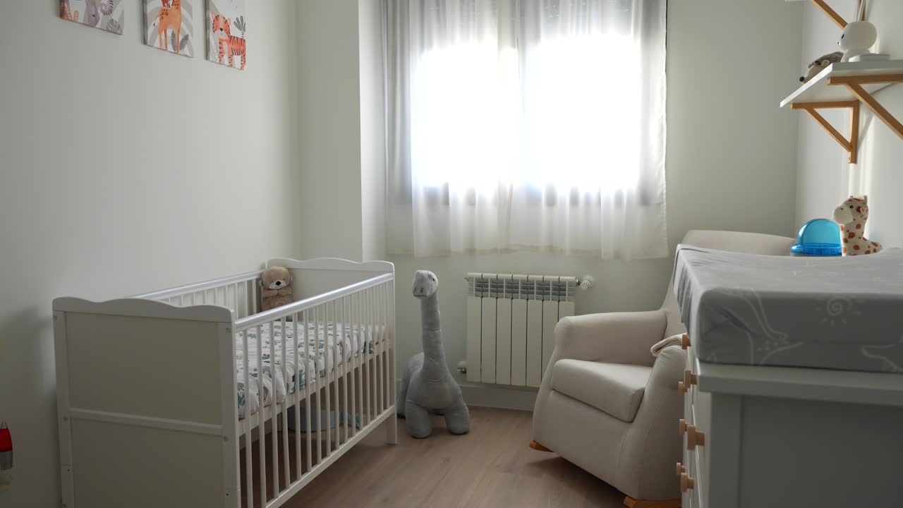 Baby room with crib and toys, panning shot capturing peaceful waiting moment