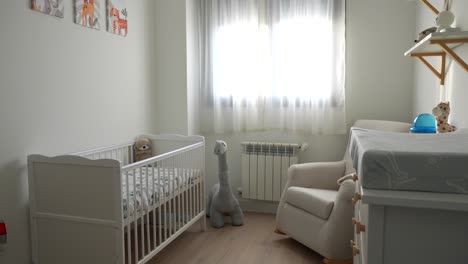 baby room with crib and toys, panning shot capturing peaceful waiting moment