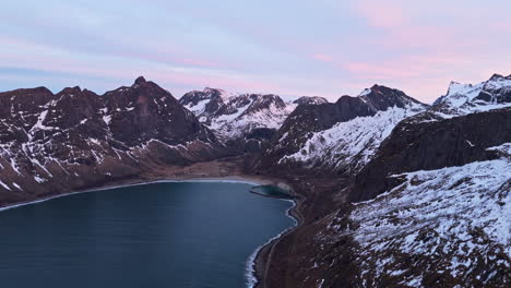 Snow-capped mountains and a secluded beach at Tungeneset, Senja, during sunset